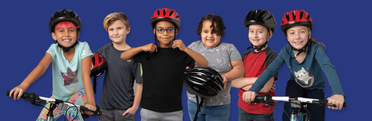 six kids wearing or holding bicycle safety gear